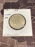 Reverse side of the 1941 GB two shillings silver coin showing denomination and crown design.
