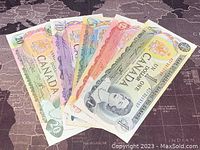 Five Canadian banknotes from the 1970s laid out side by side showing the $1, $2, $5, $10, and $20 denominations.