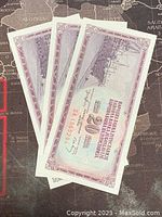 Three Yugoslavian 20 Dinara banknotes laid overlapping showing fronts, placed on a map background.