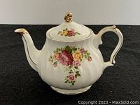 Side view of Sadler porcelain tea pot with floral patterns and gold trim