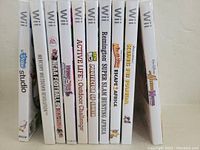 Photo showing 10 Wii game cases lined up, titles visible on spines to identify games included