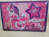Closed pink hard case with cartoon character and 'Starring Role!' text, brand 'Act' visible