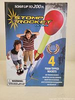 Front of box showing Stomp Rocket Ultra branding, image of children with stomp rockets, and text indicating rockets can soar up to 200 feet.
