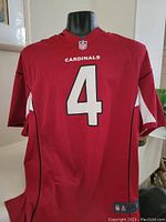 Front view of red Arizona Cardinals jersey with number 4 and 'CARDINALS' text above the number.