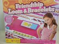 Photo of Friendship Loom & Bracelets kit packaging featuring the product and a child demonstrating made bracelets.