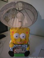 Front view of SpongeBob SquarePants lamp with fitted lampshade showing character details and bulb holder.