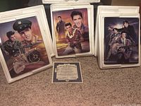 Three ceramic plaques featuring Elvis Presley and Certificate of Authenticity on floor.