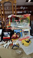 Image showing an assortment of Elvis Presley Christmas ornaments including boxed jukebox ornaments, an Elvis stocking, and multiple Elvis figurine ornaments.