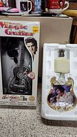 Photo of unopened electronic Magic Guitar box with image of Elvis Presley and miniature black guitar inside.