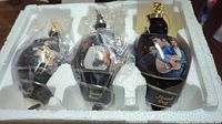 Three Elvis themed ornaments in original foam box, wrapped in plastic, named Hound Dog, Teddy Bear, and All Shook Up.