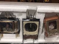 Three Bradford Exchange Elvis Presley miniature TV ornaments in original styrofoam packaging, each representing vintage TV with different Elvis images.
