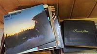 Vinyl LP records stacked with visible albums including Barry Manilow and Engelbert Humperdinck, with black record album holder.