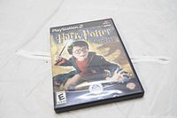 Front cover of the Harry Potter and the Chamber of Secrets PS2 game case showing the main character Harry Potter with wand.