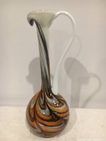 Front view of the blown glass vase showing tall slender neck, handle and swirled color pattern