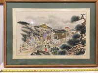 Framed watercolor painting showing a traditional Korean procession scene including people, horses, umbrella, and palanquin, with calligraphy and artist stamps, framed under glass with green matting and wood frame.