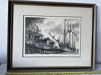 Full view of the framed black and white etching titled 'William L. White' depicting a historic sailing ship docked near waterfront buildings, showing frame and matting with glass cover.