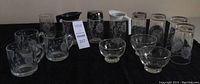 Full overview of the vintage Cornflower glassware set including creamer, sugar bowl, glasses, mugs, and bowls all etched with cornflower pattern.