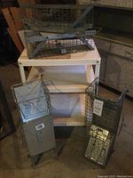Overview of steel shelving unit with four wire baskets to show lot contents and condition