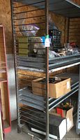 Front view of a steel shelving rack loaded with various small items (not included).