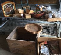 Overview photograph showing the wooden crate box, wooden spice rack, wooden boxes, and wooden bowl filled with cabinet knobs, along with plastic bags containing additional hardware.