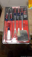Front view of unopened blister pack showing all five barbecue tools with Craftsman branded handles.