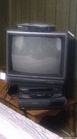Magnavox 19-inch CRT TV with two VCRs stacked below it. The devices are dusty and untested.