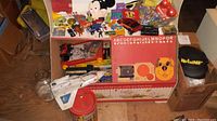 Photo showing assortment of toys including Captain Power Power Jet, Hess truck, Bristle Blocks set, and toy box with alphabet and dog face graphics