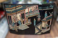 Full view of the four-panel Asian wall art plaque showing the complete scene of traditional figures on balconies and stairs with lacquered black background.