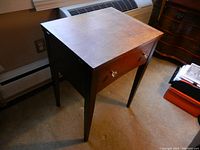 Front and side view of Kenmore sewing machine table with glass accent knobs on faux drawer.