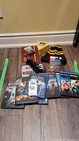Overall view showing Harry Potter DVDs, feather pen, toque, UNO cards, and Trivial Pursuit cards