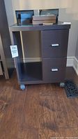 Front view of wheeled table showing two drawers on the right and open storage on the left.
