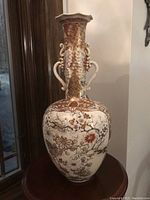 Full front view of the Chinese famille rose porcelain vase showing floral and gilt butterfly decoration