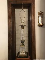 Full view of the lamp without lampshade, showing diamond/lattice patterned glass sections and brass base with gold leaf accents.