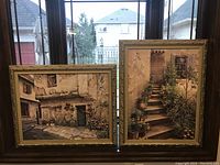 Front view of two large custom framed Mediterranean scene prints, one horizontal and one vertical, displayed side-by-side in a window.
