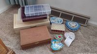 Overview of the eleven boxes including wooden jewelry boxes, metal heart tins, ceramic pillbox, and plastic compartment box