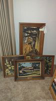 All four wood framed screen prints on linen arranged together on carpeted floor.