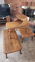 Full view showing both vintage wooden coffee tables alongside the two-tier wooden side table with the smaller upper tier elevated.