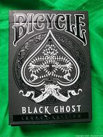 Box of Bicycle Black Ghost Legacy Edition playing cards with embossed design and lettering on front.