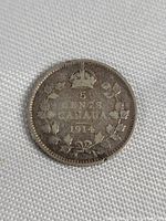 Reverse of the 1914 Canada 5 cent silver coin with denomination, crown, and wreath design.