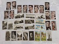 Photo showing a variety of early collectible cards including portraits, landscapes, and colored scenic cards.