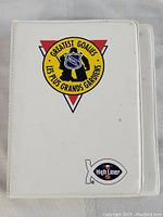 White plastic binder with NHL Greatest Goalies logo and High Liner Foods sticker visible on front cover.