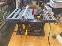 Front angle view of the Mastercraft 10 inch bench saw showing table surface, measurement markings, adjustment knobs and saw blade section.