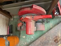 Top view of the red Milwaukee abrasive cut-off machine showing the motor housing, handle, and power cable.