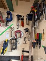 Grouping of cast iron C-clamps in red and silver finish