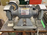 Front view of Baldor grinder mounted on work table showing both wheels, base and power cord