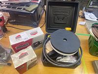 Two Jobmate boxes, one for the detail sander and one for the jig saw, displayed on a wooden surface.