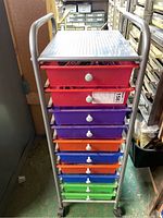 Full front view of metal rolling cart with 10 colorful drawers stacked vertically.