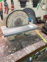 Front view of the Craftex disc sander showing the worn circular sanding disc and the aluminum table work surface.