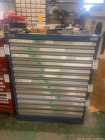 Front view of blue Banner metal tool chest with grey drawers