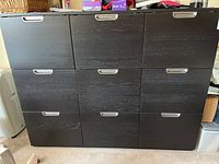 Full front view of the 9 drawer filing cabinet showing its black wood finish and metal handles.